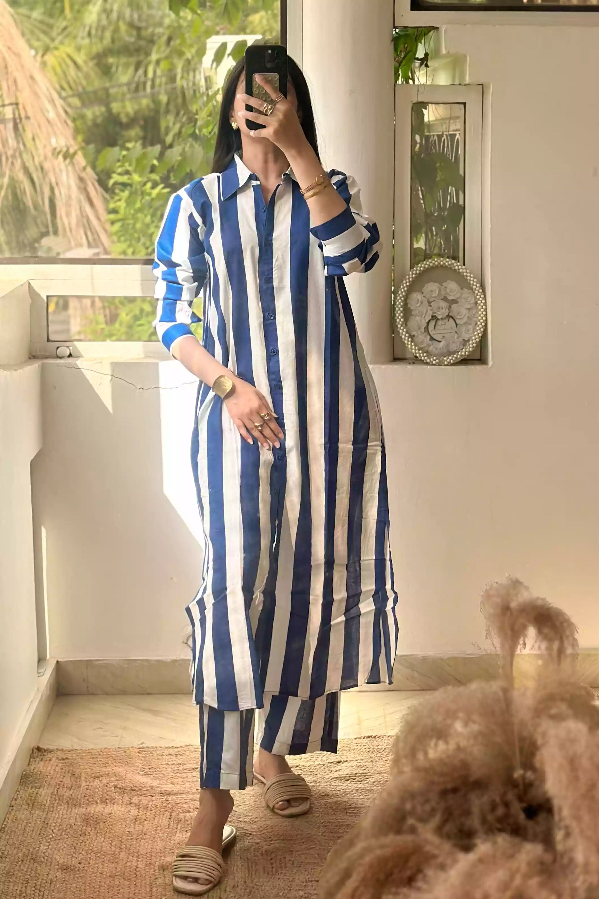 Woman wearing blue stripe cotton button-down shirt